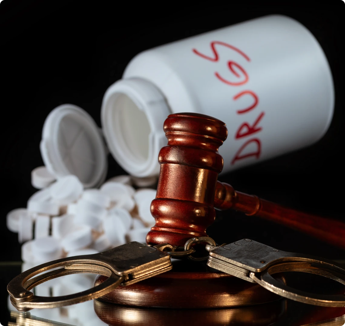 Drugs, gavel, handcuffs depict law enforcement.