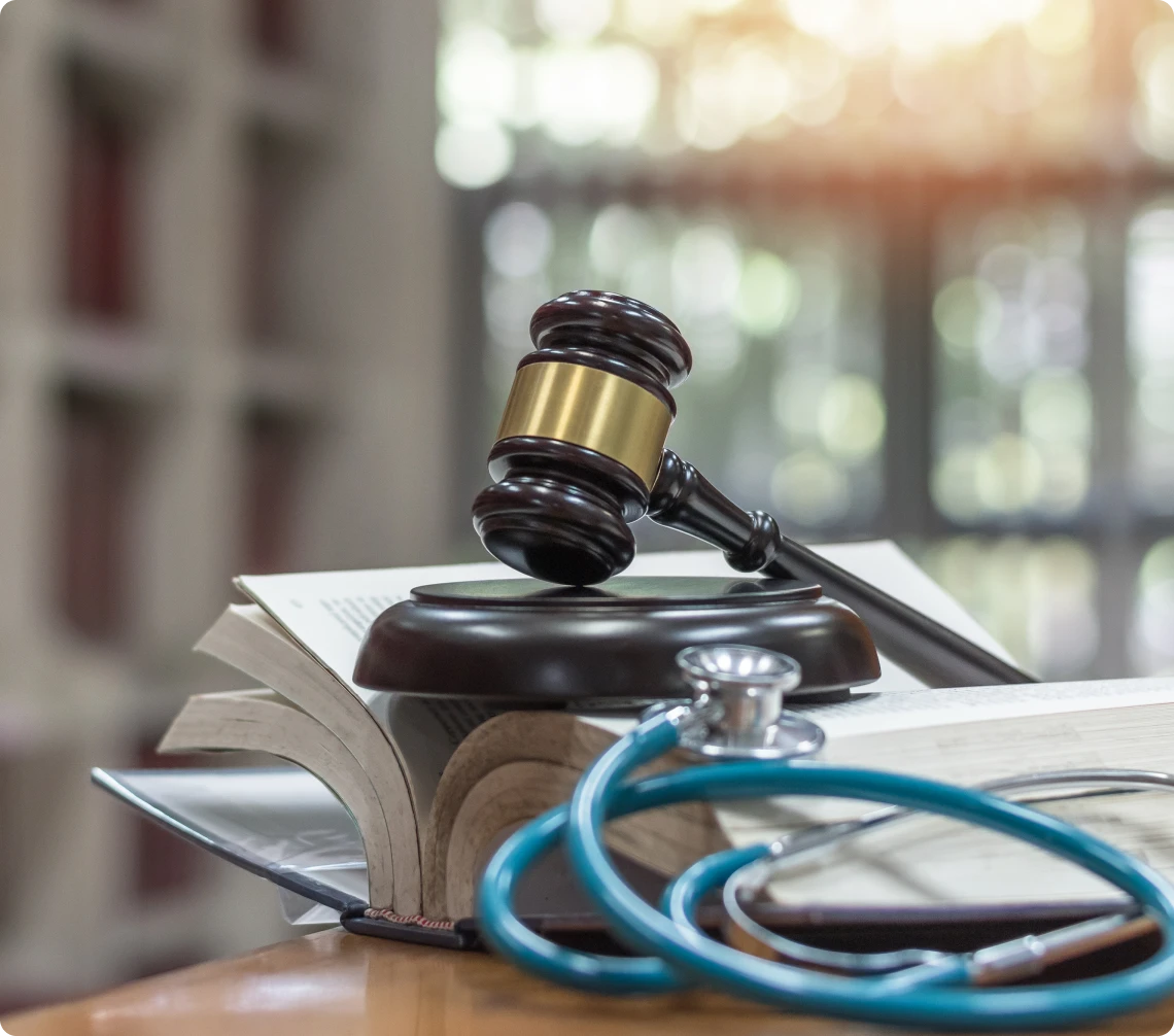 Legal and medical symbols on table