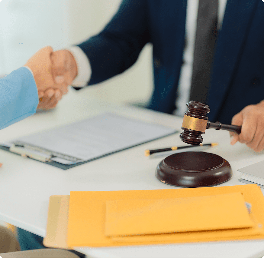Handshake over legal documents and gavel